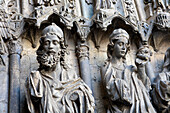 Intricate gothic statues adorn the San Francisco portal of León Cathedral in Spain, showcasing remarkable craftsmanship and history.