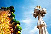 Barcelona, Spain, Sept 4 2008, Colorful ceramic decorations adorn the rooftop of Casa Batlló, showcasing Gaudís unique architectural style under a clear blue sky.