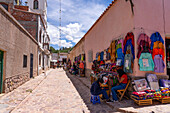 Street vendors on a cobblestone street in Humahuaca in the Humahuaca Valley or Quebrada de Humahuaca, Argentina.