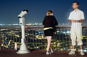 Barcelona, Spain, Sept 4 2008, A young couple admires the stunning nighttime cityscape from the Tibidabo viewpoint in Barcelona, surrounded by sparkling lights.