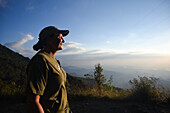 Woman enjoying a beautiful sunset in Sierra Nevada de Santa Marta, Colombia