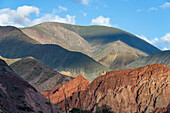 First light on the colorful mountains of the Eastern Cordillera of the Andes from Purmamarca, Argentina.