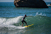 Surfers in Grande Plage beach of Biarritz, France