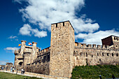 Ponferrada, Spain, Aug 19 2008, Visitors explore the ancient walls of the Temple Castle in Ponferrada under a clear blue sky, enjoying the rich history of the site.