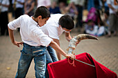 Seville, Spain, June 11 2009, Young bullfighter trainees engage in toreo de salon at Alameda de Hercules square, showcasing their skills and techniques.