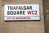 A sign indicating Trafalgar Square in the City of Westminster, an iconic London location known for its historical significance.