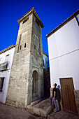 Ronda, Spain, Sep 22 2007, A visitor admires the historic San Sebastian minaret in Ronda, illuminated in the evening light of Andalusia.