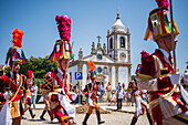 Parade passing by São João Baptista Church during The Festival of Saint John of Sobrado, also known as Bugiada and Mouriscada de Sobrado, takes place in the form of a fight between Moors and Christians , locally known as Mourisqueiros and Bugios, Sao Joao de Sobrado, Portugal