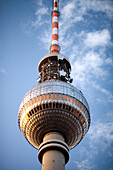 The stunning Fernsehturm towers high above Berlin, showcasing the city\'s vibrant skyline against a clear blue sky.