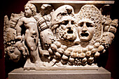 Berlin, Germany, July 24 2009, This ancient marble sarcophagus features ornate masks and a cherub, showcasing art from the 2nd century AD, displayed in Berlin.