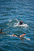 Surfers in Grande Plage beach of Biarritz, France