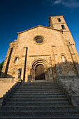 The entrance of the historic Iglesia de Santa María de Almocóvar showcases its ancient architecture and majestic stairs.