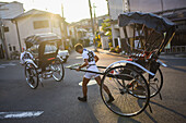 Rickshaw man at sunset in Kyoto, Japan