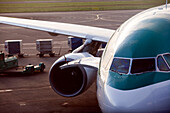 An airplane awaits clearance on the tarmac at Dublin Airport, ready for its journey amidst the bustling airport environment.