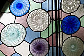 Barcelona, Spain, Sept 4 2008, Vibrant stained glass with swirling patterns enhances the beauty of Casa Batlló, a Gaudí masterpiece in Barcelona.