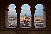 View of Parliament building, Chain Bridge and Danube River through old columns, Budapest, Hungary, Europe