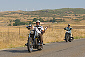 Two bikers driving Harley-Davidson.