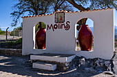 The colonial-style architecture welcome sign for the town of Molinos, Argentina in the Calchaqui Valley.