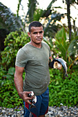 Portrait of local fisherman carrying fish in Tayrona National Park, Santa Marta, Colombia