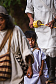 Kogi mamo (priest) and family walking through the forest.