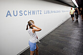 Berlin, Germany, July 27 2009, A young visitor engages with the Holocaust exhibit in the Jewish Museum, highlighting its educational significance in Berlin.