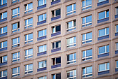 A close view of the modern facade of the Stelzenhaus, showcasing its unique window arrangement in Berlin\'s Mitte district.