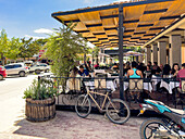 Visitors dining al fresco at restaurants around the main plaza in Cafayate, Argentina.