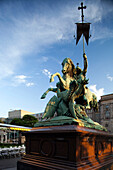 The iconic Saint George statue stands majestically in Nikolaiviertel, Berlin, bathed in evening light, showcasing its impressive details.