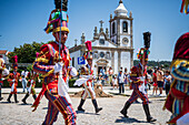 Parade passing by São João Baptista Church during The Festival of Saint John of Sobrado, also known as Bugiada and Mouriscada de Sobrado, takes place in the form of a fight between Moors and Christians , locally known as Mourisqueiros and Bugios, Sao Joao de Sobrado, Portugal