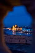 Illuminated Parliament building and Danube River it night, Budapest, Hungary, Europe