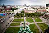 A beautiful aerial view reveals Lustgarten, with people enjoying the park in the heart of Berlin from the dome of the Cathedral.