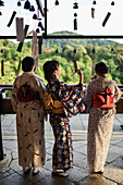 Three young women dressed in traditional Japanese clothes, Kiyomizu-dera temple in Kyoto, Japan