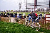 People watching a soccer youth game in small town of Hungary