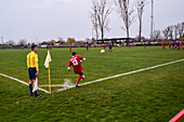 Corner kick during soccer youth game in small town of Hungary