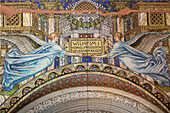 This intricate mosaic features angels holding a plaque at the historic Kaiser Wilhelm Memorial Church in Berlin, Germany.