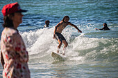 Surfers in Grande Plage beach of Biarritz, France