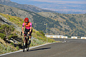 Rider climbing the mountain pass. La Morcuera, Community of Madrid.