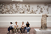 Berlin, Germany, July 24 2009, Tourists explore the intricate Hellenistic sculptures of the Pergamon Altar at the Pergamon Museum in Berlin, Germany.