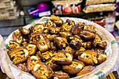 Dates stuffed with nuts in the shops along narrow cobblestone streets of Kasbah in Bab Al Fahs, old Medina, Tangier, Morocco, North Africa, Africa