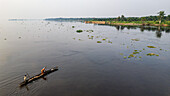 Aerial of a dugout canoe on the Congo River, Mbandaka, Equateur province, Democratic Republic of Congo, Africa