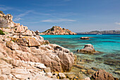 View from rocks across the clear turquoise waters of Cala Corsara to the pink granite headland of Punta Rossa Corsara, Spargi Island, La Maddalena Archipelago National Park, Sassari, Sardinia, Italy, Mediterranean, Europe