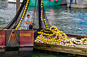 Fishing net and fishermen on boat in town of Petersburg on Mitkof Island, Southeast Alaska, Pacific Ocean, United States of America, North America