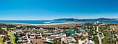 Aerial drone panoramic view of Troia, a peninsula located in Grandola Municipality, next to Sado River estuary, with Arrabida mountain range on left, Alentejo, Portugal, Europe