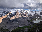 Snow-capped peaks and lush valleys at sunset showcased in a stunning landscape, Kyrgyzstan, Central Asia, Asia