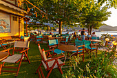 View of restaurant in old harbour in Thassos Town during golden hour, Thassos, Aegean Sea, Greek Islands, Greece, Europe