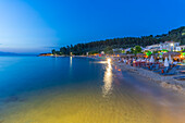 View of restaurant on beach at dusk, Thassos Town, Thassos, Aegean Sea, Greek Islands, Greece, Europe