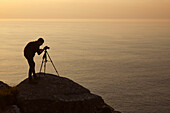 A landscape photographer at work, on the Bristol Channel coast at the Valley of Rocks, near Lynton, Exmoor National Park, Devon, England, United Kingdom, Europe