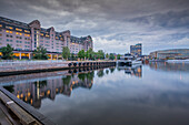 View of architecture reflecting in harbour on cloudy evening, Oslo, Norway, Scandinavia, Europe