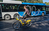 Young cyclist by tram in a street in Helsinki ,Finland, Europe