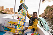 Young guide-card salesman on board a tourist boat heading towards the Temple of Isis, Temple of Philae, Agilkia Island, Aswan, Egypt, North Africa, Africa